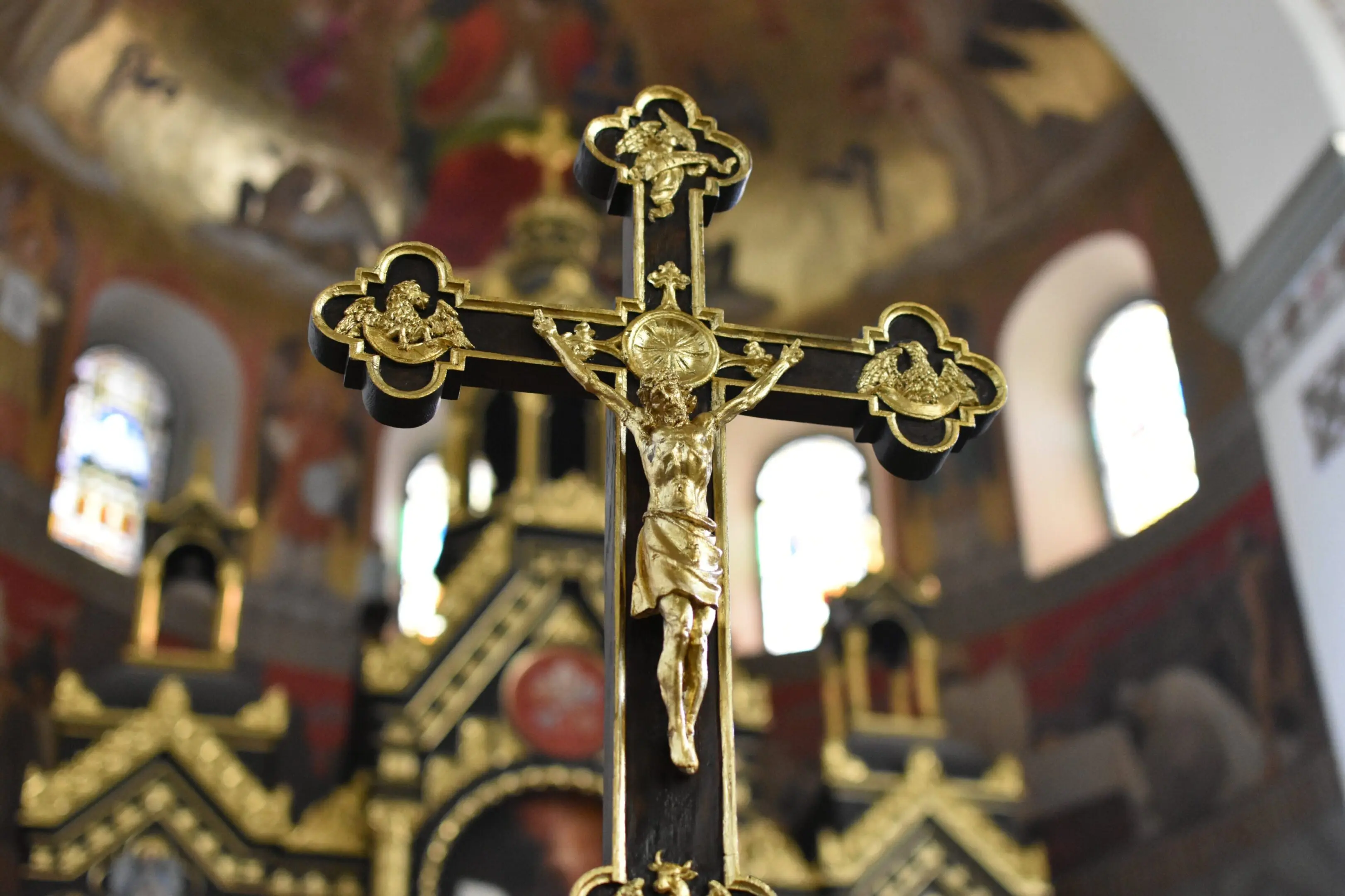 A cross with gold paint and some other decorations