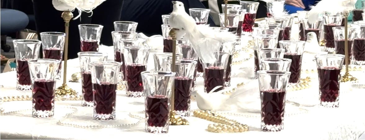 A table with many glasses of wine on it