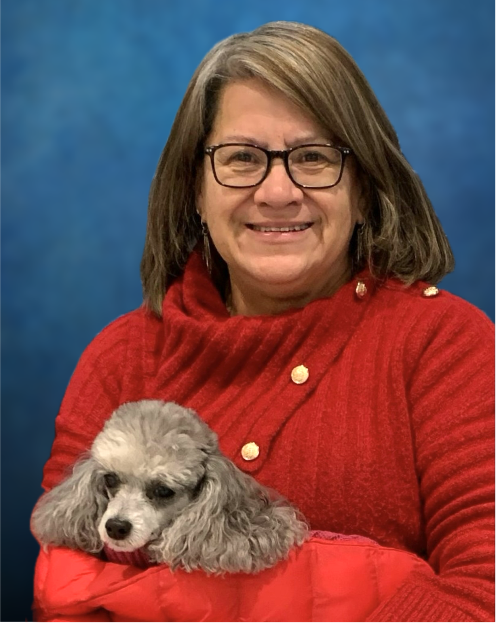 A woman holding a dog in her lap.