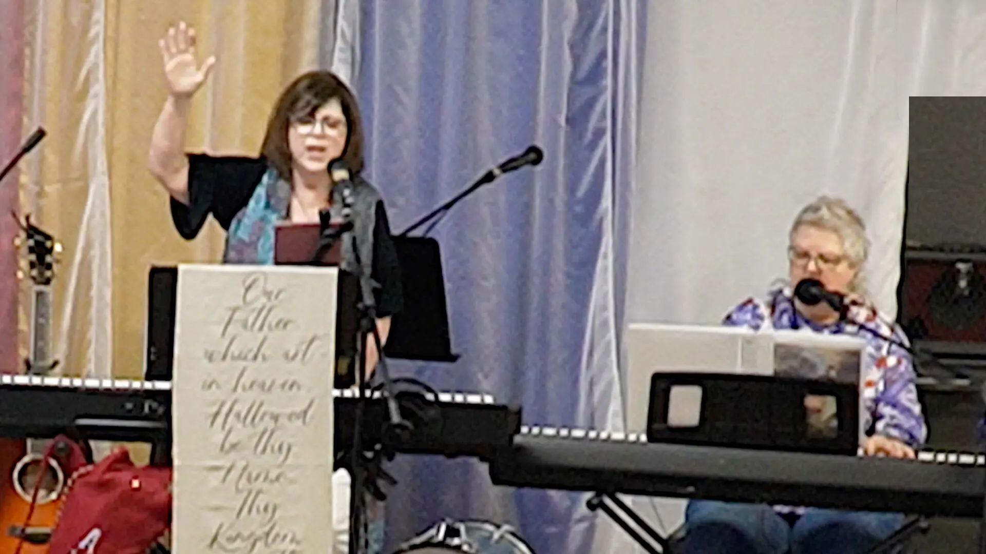 A woman standing at the podium with a microphone.