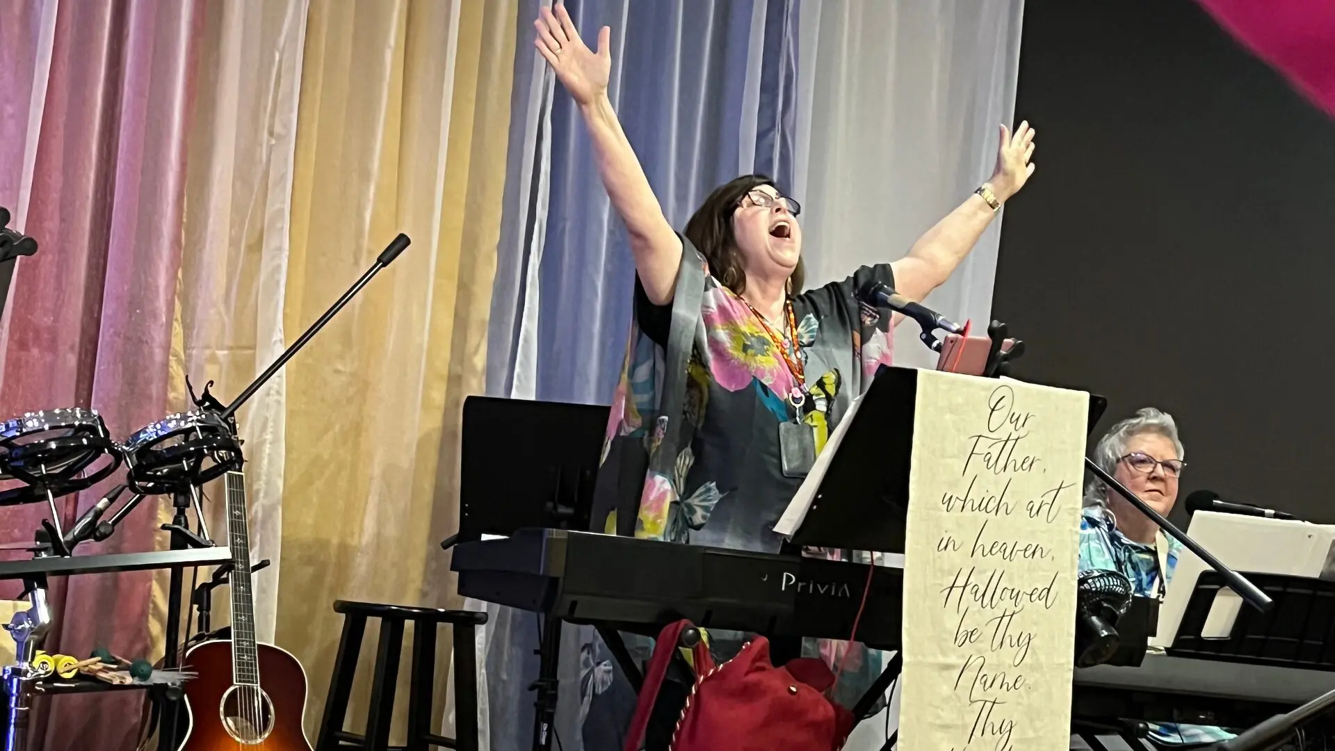 A woman is singing at the piano