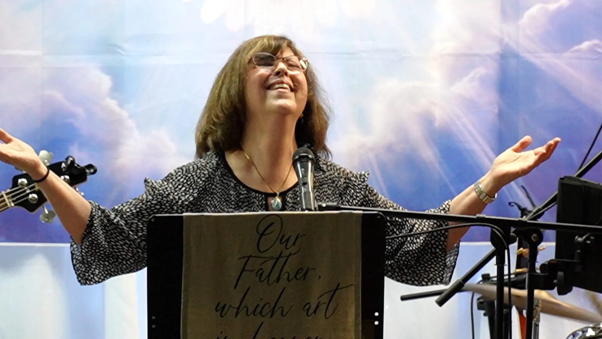 A woman standing at the top of a podium.