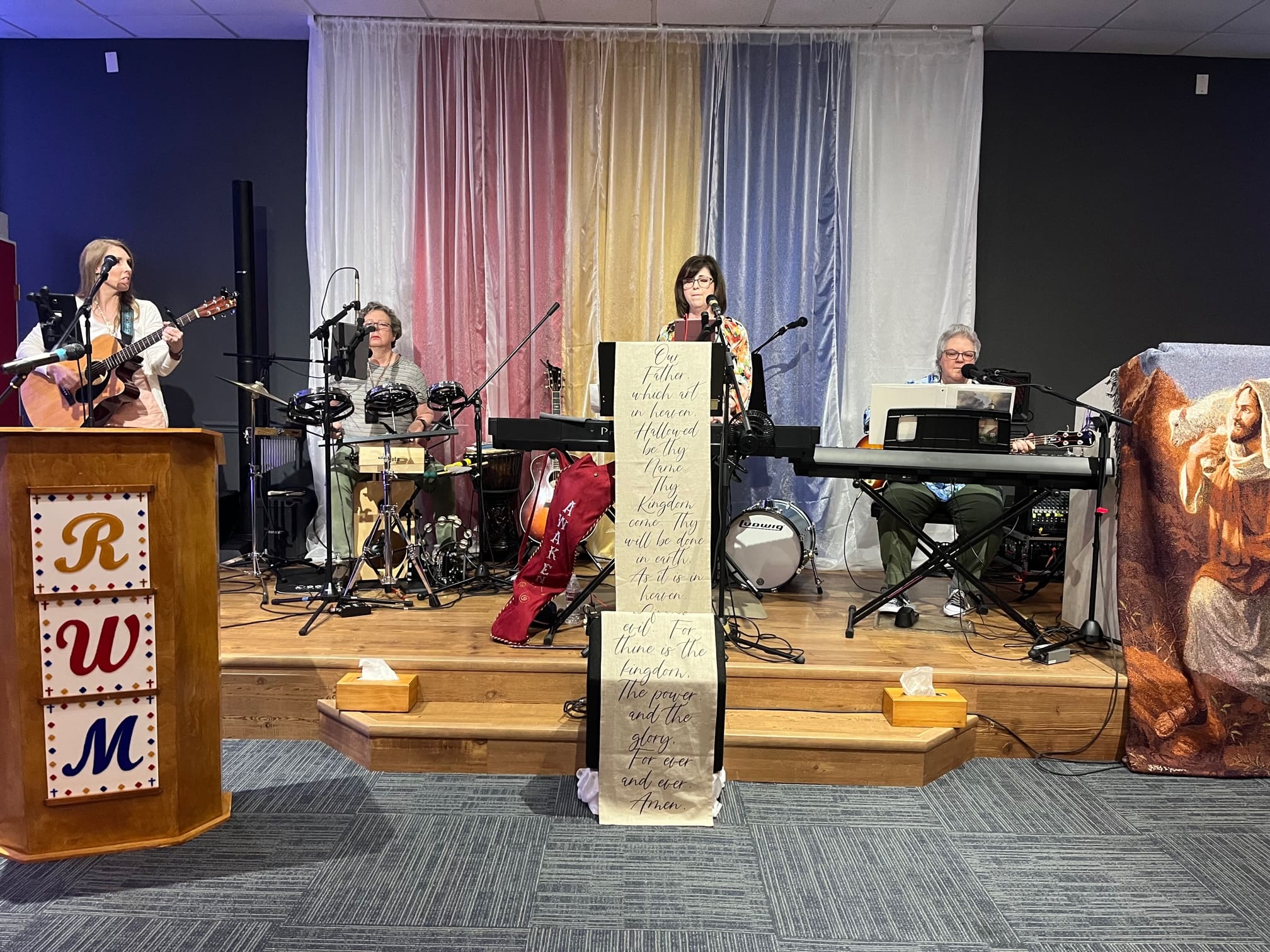 A group of people playing instruments on stage.