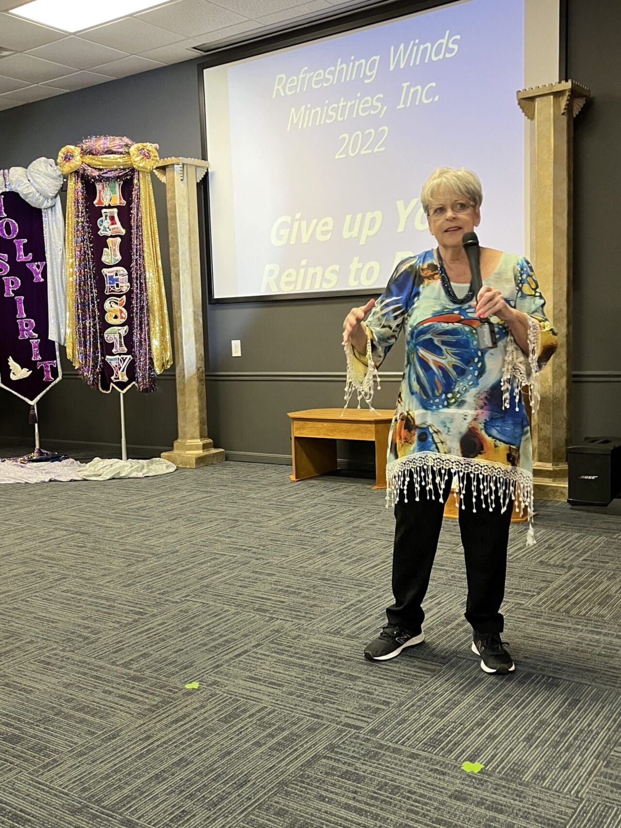 A woman standing in front of a microphone.