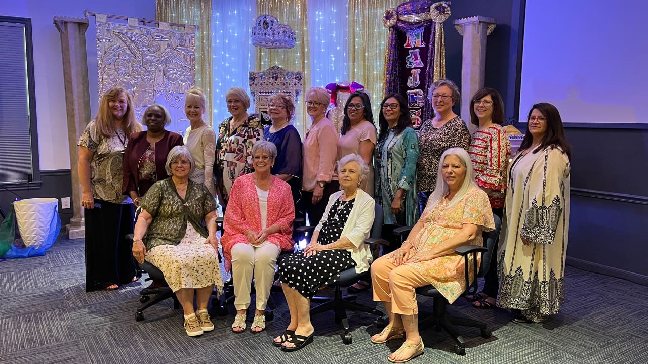 A group of older women posing for a picture.