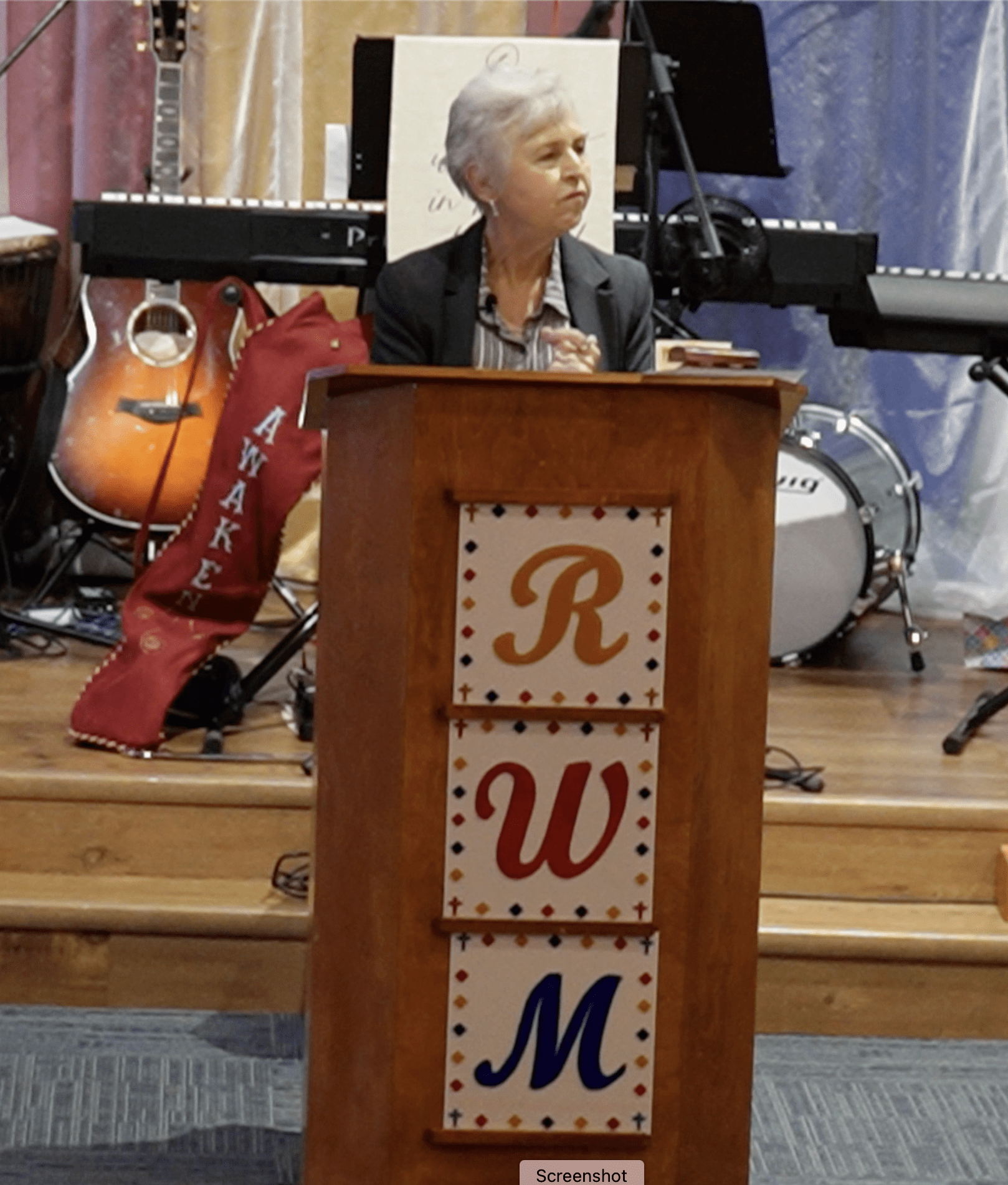 A woman standing at the top of a podium.