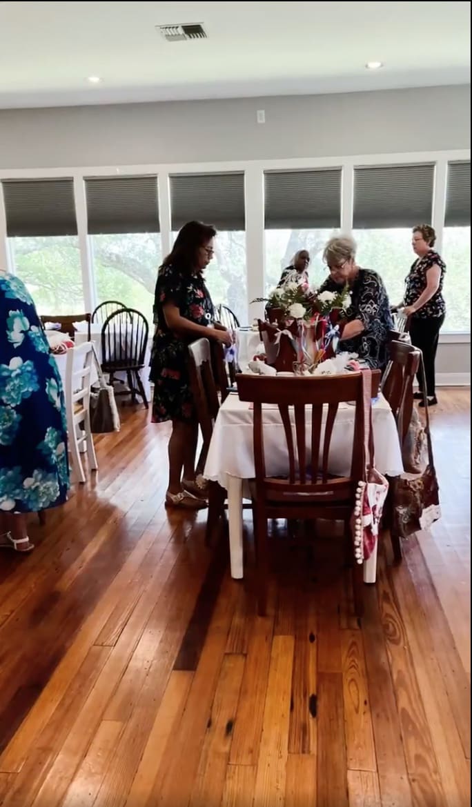 A group of people standing around a table.