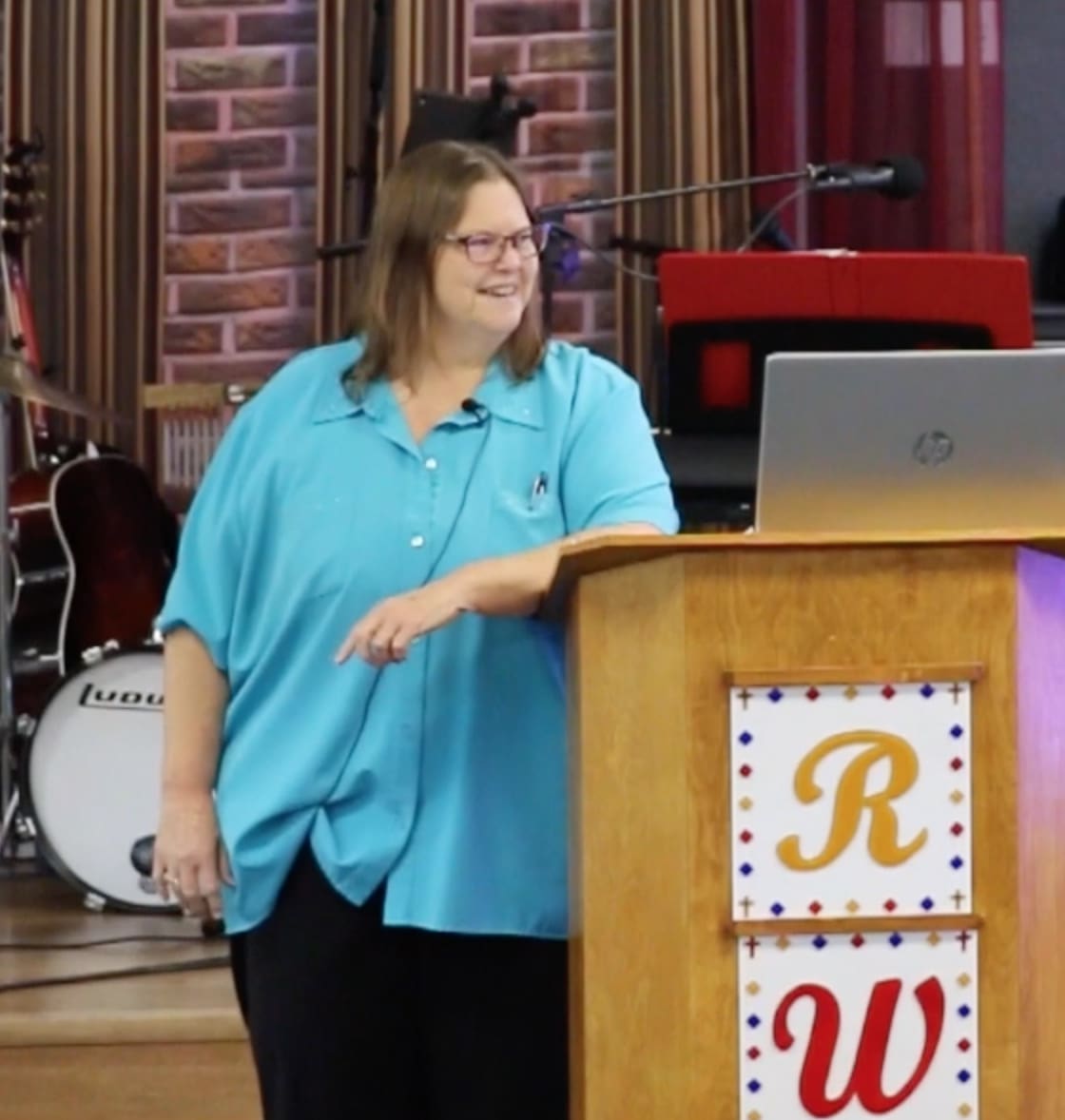 A woman standing at the front of a podium.