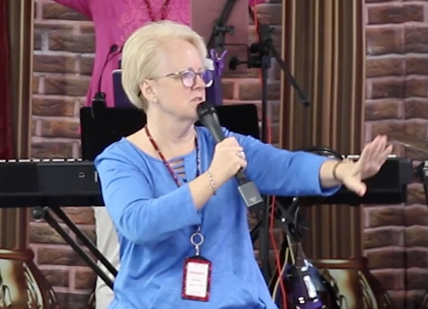 A woman holding a microphone in her hand.