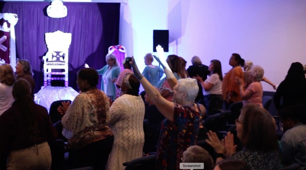 A group of people standing in front of a stage.