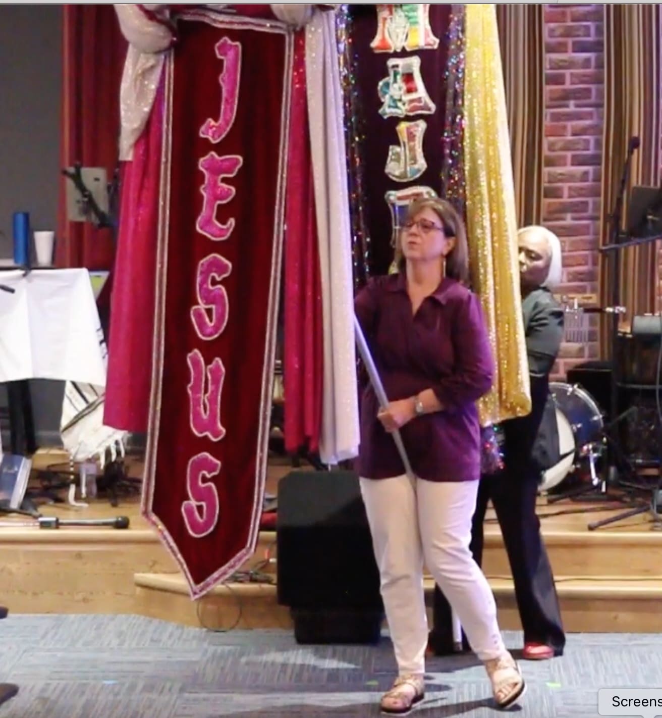 A woman standing next to a bunch of banners