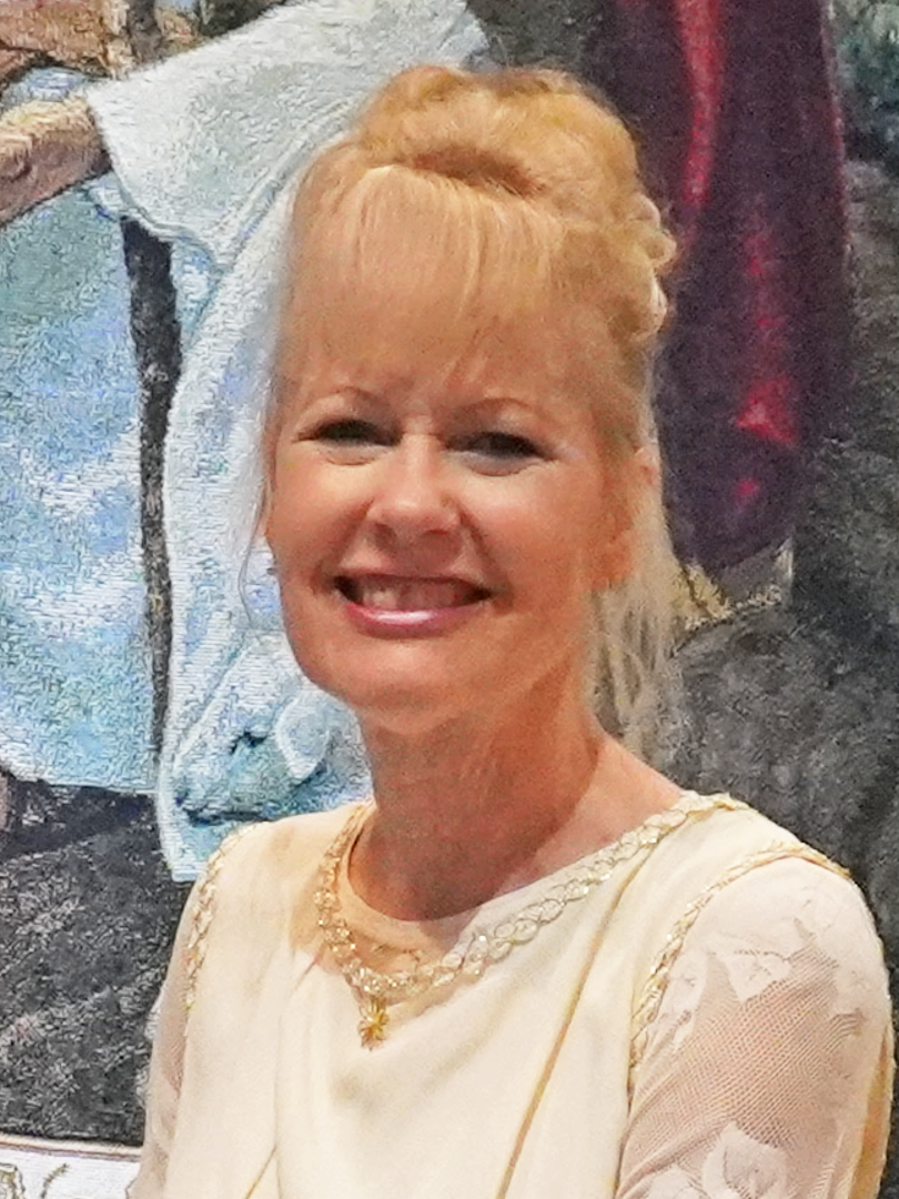 A woman with blonde hair and a white dress.