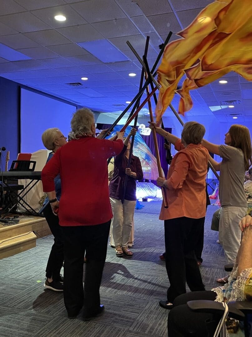 A group of people standing around holding up flags.