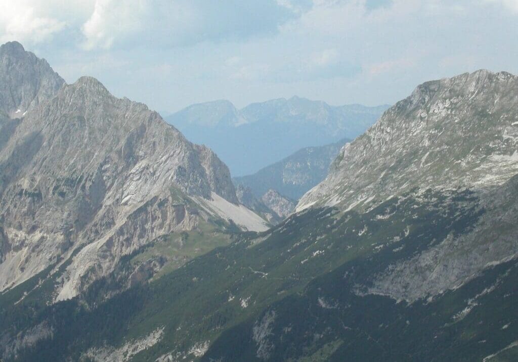 A view of some mountains from the top of a mountain.