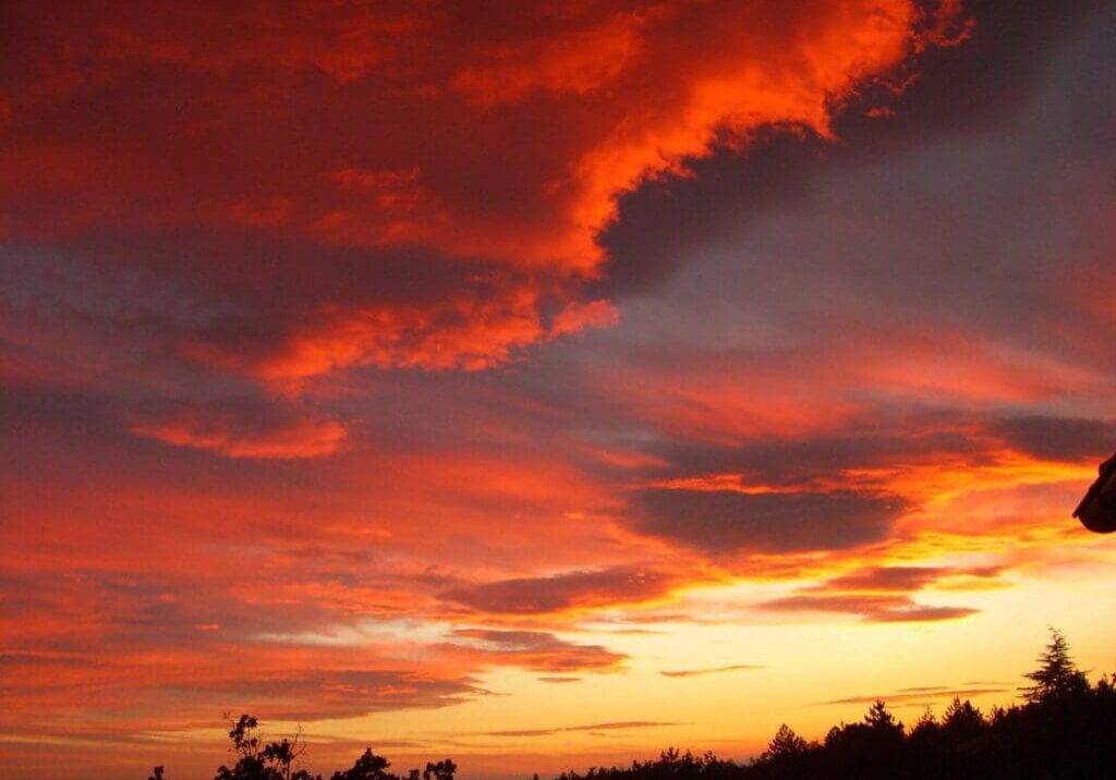 A red sky with clouds at sunset.